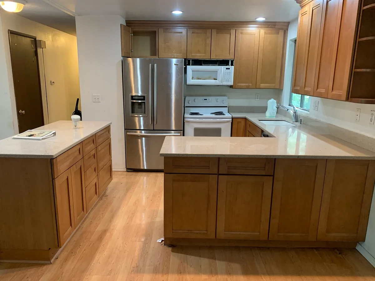 Before: kitchen with oak cabinets and laminate countertops