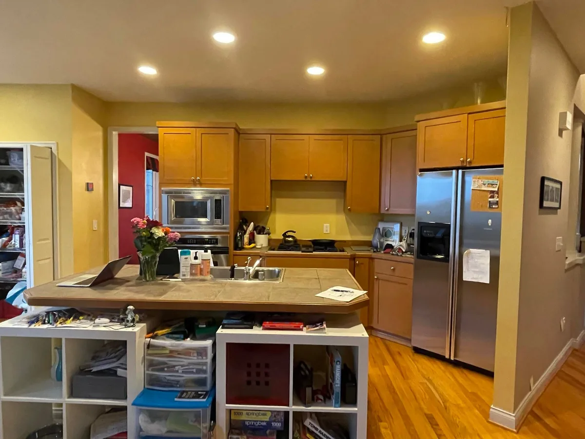 Before: dated kitchen with oak cabinets and a tile-top island